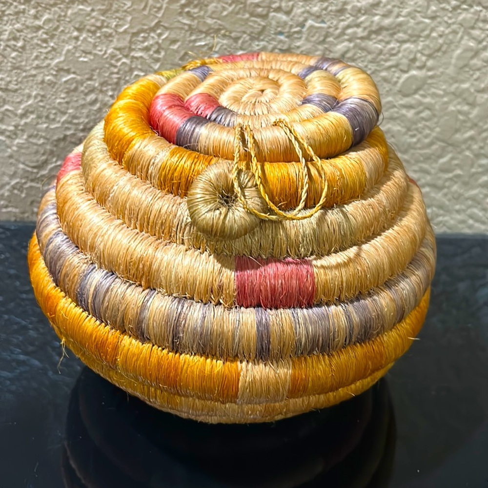 Vintage coiled handmade woven basket with attached lid